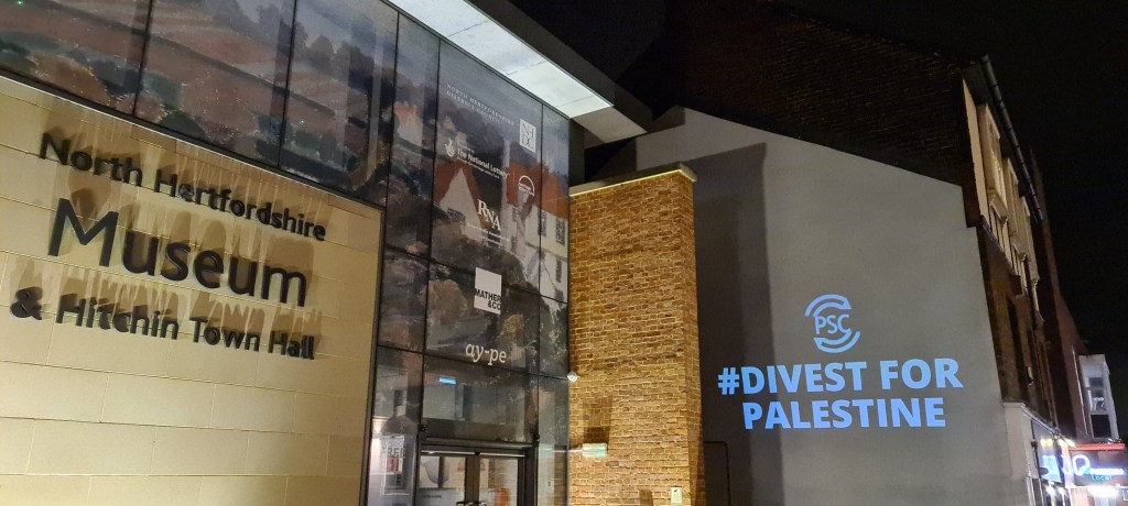 North Hertfordshire Museum and Hitchin Town Hall, with the text "Divest for Palestine"